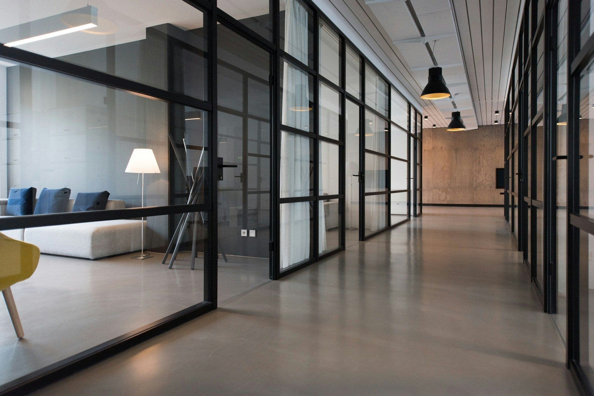 Clean, polished commercial corridor with glass partition offices